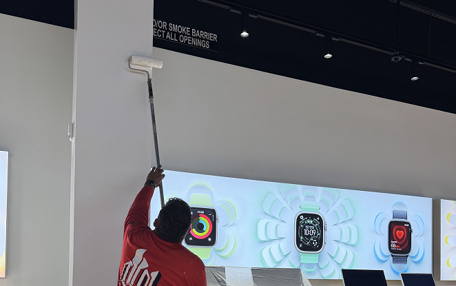 Painter working on interior wall