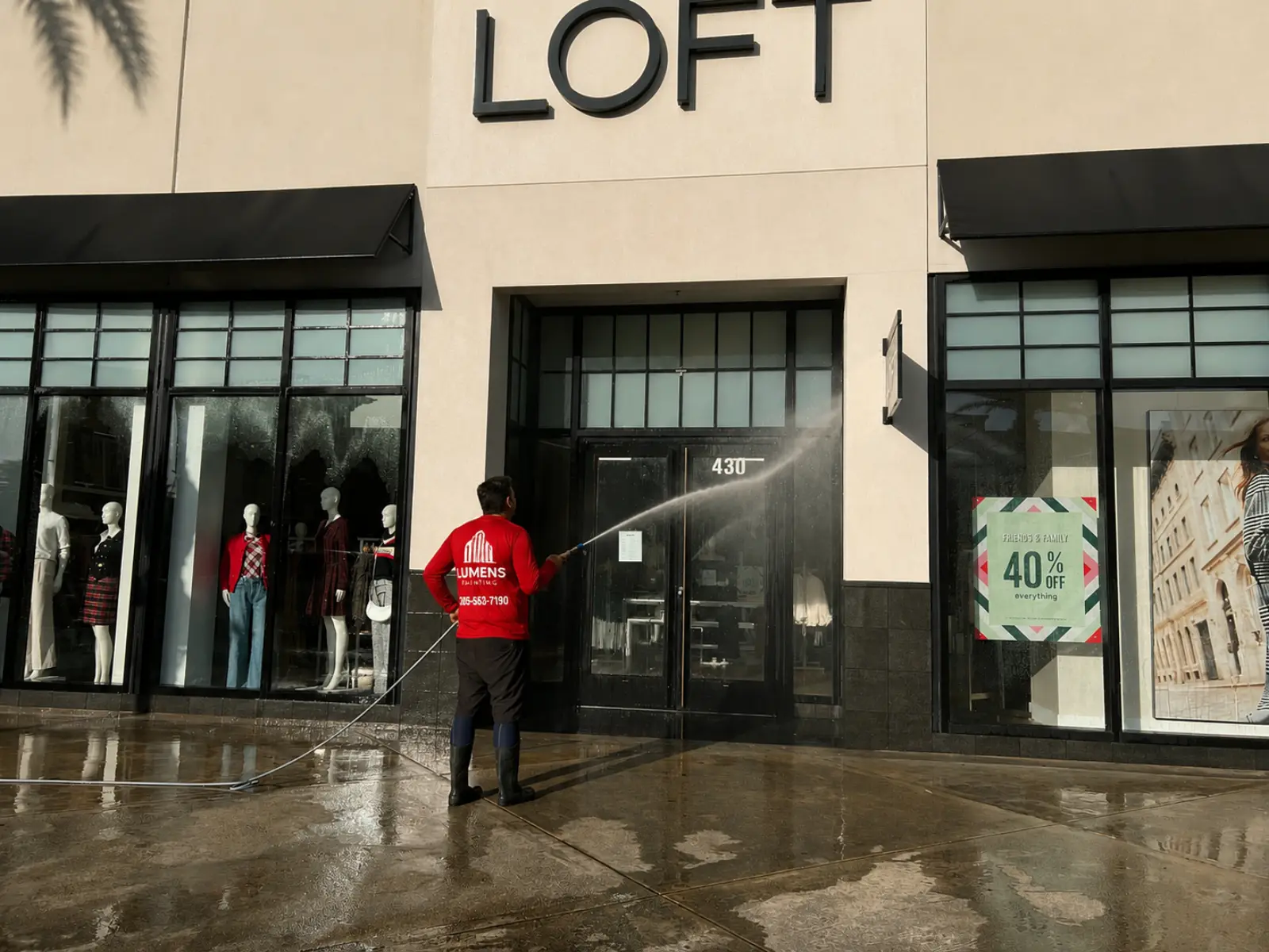 Lumens Painting commercial storefront cleaning at a South Florida shopping center